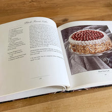Load image into Gallery viewer, This fabulous vintage hardcover cookbook features decadent cake recipes straight from the makers of Hershey&#39;s chocolate, one of the world&#39;s most recognizable brands! Its 122 pages are filled with amazing recipes along with many colour photographs. All recipes developed by Marjorie Anderson and tested in the Hershey Kitchens. Published by Joshua Morris Publishing, 1992.   In great  condition!   
