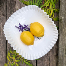 Load image into Gallery viewer, This vintage  &quot;Hobnail&quot; pressed milk glass low banana stand brings all the drama! It features a low foot, with folded sides and a crimped edge. Crafted by the Fenton Art Glass, USA, circa 1970s. A graceful piece of pressed glass in a classic pattern that will always be in style no matter your decor style. Fill with your favourite fruits and display!  In excellent condition, free form chips/cracks.  Measures 12 x 9 x 4 1/2 inches
