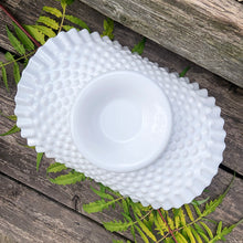 Load image into Gallery viewer, This vintage  &quot;Hobnail&quot; pressed milk glass low banana stand brings all the drama! It features a low foot, with folded sides and a crimped edge. Crafted by the Fenton Art Glass, USA, circa 1970s. A graceful piece of pressed glass in a classic pattern that will always be in style no matter your decor style. Fill with your favourite fruits and display!  In excellent condition, free form chips/cracks.  Measures 12 x 9 x 4 1/2 inches
