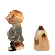 Load image into Gallery viewer, Rare vintage hand painted hobo tipping his top hat and suitcase ceramic salt and pepper shakers with corks. Enesco, Japan, 1950s. Add these unique shakers to your collection!

In excellent vintage condition, no chips/cracks/repairs. Original stickers.

Hobo measures 2 1/4 x 1 5/8 x 3 1/4 inches, suitcase measures 2 1/2 x 1 1/4 x 2 inches
