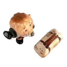 Load image into Gallery viewer, Rare vintage hand painted hobo tipping his top hat and suitcase ceramic salt and pepper shakers with corks. Enesco, Japan, 1950s. Add these unique shakers to your collection!

In excellent vintage condition, no chips/cracks/repairs. Original stickers.

Hobo measures 2 1/4 x 1 5/8 x 3 1/4 inches, suitcase measures 2 1/2 x 1 1/4 x 2 inches
