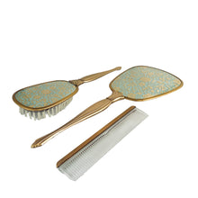 Load image into Gallery viewer, Vintage Hollywood Regency 3-piece gold-toned vanity grooming set featuring turquoise and gold lace floral backing on the mirror and hairbrush with a clear/gold plastic comb. A beautiful set! Each piece is in like-new condition, in original box.
