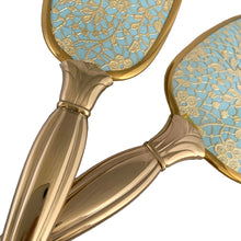 Load image into Gallery viewer, Vintage Hollywood Regency 3-piece gold-toned vanity grooming set featuring turquoise and gold lace floral backing on the mirror and hairbrush with a clear/gold plastic comb. A beautiful set! Each piece is in like-new condition, in original box.
