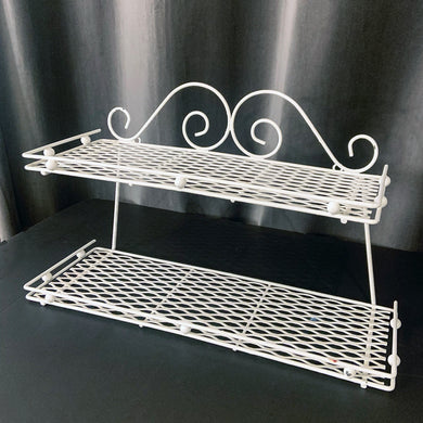 Vintage mid-century era, Hollywood Regency metal two tier wire mesh wall shelf in white.  In great vintage condition, some wear to the paint.  Measures 16 1/4 x 5 1/2 x 9 1/2 inches