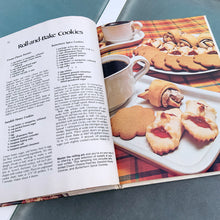 Load image into Gallery viewer, Better Homes and Gardens is known for its fabulous cookbooks. This hardcover cookbook focuses on homemade cookie recipes. Its 96 pages are filled with amazing recipes along with many colour photographs. Originally published by Meredith Corporation, USA, 1975. This is the large format edition, fifth printing, 1984.   In great vintage condition with normal age-related yellowing.   
