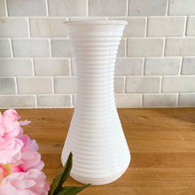 Load image into Gallery viewer, Vintage horizontal ribbed milk glass vase. Whether adorned with flowers or left bare, it adds a touch of beauty to any setting. Its timeless design makes it suitable for various decor styles, from farmhouse and shabby chic to cottage core, and perfect for wedding or bridal decorations. In excellent condition, no chips or cracks. Measure 4 x 8 3/4 inches
