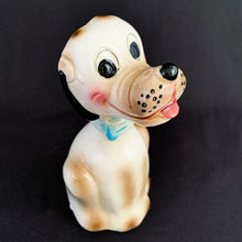 Load image into Gallery viewer, Show off the playful charm of this adorably freckle faced ceramic hound dog figurine! Its wide-eyed expression and pink tongue will add a dash of fun to any room. This beige, tan and black canine features a classic blue bow tie and is sure to charm everyone who sees it!  In excellent condition, free form chips/cracks/repairs. Marked &quot;Japan&quot; on the bottom.  Measures 2 x 4 1/2 inches
