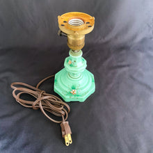 Load image into Gallery viewer, This uniquely shaped and rare vintage depression era art deco style green uranium slag glass boudoir table lamp features an octagonal base with hand painted enamel flowers in shades of pink, blue, green and brown. Created and crafted by Houze Art Glass in the USA, circa 1930. The best part is that lovely lamp glows brilliantly under black light. The lamp base with socket measures 3 7/8 x 7 inches. Original cord.
