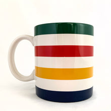 Load image into Gallery viewer, Classic vintage HBC Stripes ceramic coffee tea handled mug. Produced for the Hudson&#39;s Bay, Canada.   In excellent condition, free form chips/cracks. Marked with the HBC logo with the 2 deer stags on their hind legs and the Latin phrase &quot;Pro Pelle Cutem&quot;, meaning “a pelt for a skin”, which is the traditional motto of the Hudson&#39;s Bay Company (HBC). Dishwasher and microwave safe.  Measures 3 1/4 x 3 3/4 inches  Capacity 12 ounces
