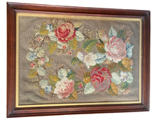 Load image into Gallery viewer, Antique Victorian floral needlepoint under glass in a dark wooden frame with gold inner trim, featuring pink and red roses
