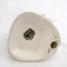 Load image into Gallery viewer, Underside of 1950s Napco Originals porcelain skunk figurine showing "JAPAN" ink stamp and original Napco Originals by Giftcraft foil label
