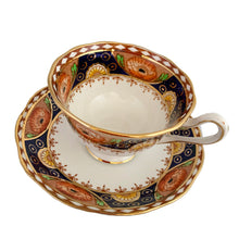 Load image into Gallery viewer, Vintage bone china Avon shaped Imari-style teacup and saucer, &quot;Un-Named Set #562&quot;. Each piece has a lovely scalloped edge featuring hand painted cobalt blue panels inset with orange poppy and yellow daisy flowers, topped by a band of white diamonds, trimmed with gold gilt. Crafted by Royal Albert, England, 1930s. Makes a beautiful gift or addition to your collection!
