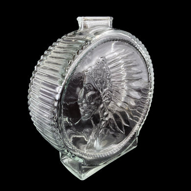 Vintage clear pressed glass coin bank featuring a buffalo on one side and a profile of a Native American in full headdress on the other. Crafted by Anchor Hocking, USA, 1970s. Save your coins with this decorative bank!  In excellent condition, no chips. Marked on the bottom with the AH logo.  2 1/8 x 6 1/2 inches
