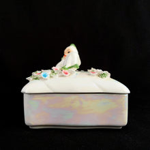 Load image into Gallery viewer, Iridescent white Lefton porcelain trinket box, side view showing reclining pixie figurine on lid with pink and blue applied flowers, lustrous pearl glaze on black background
