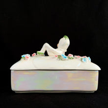 Load image into Gallery viewer, Iridescent white Lefton porcelain trinket box, back view showing reclining pixie figurine on lid with pink and blue applied flowers, lustrous pearl glaze on black background
