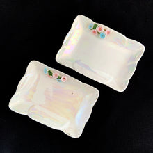 Load image into Gallery viewer, Overhead view of ESD Lefton iridescent white vanity trays with pink blue and green floral garland
