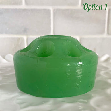 Wonderful vintage jadeite green glass flowerlite flower frog featuring 7 outer holes for flower stems and 1 central hole which is meant to hold a taper candle. Crafted by Fenton Art Glass, USA, circa 1920s, unmarked. This frog appears on page 141 of the Bull Book on Flower Frogs. A hard-to-find piece to add to your vintage glass collection. Would look heavenly paired with a jadeite bowl to create a beautiful candle lit floral centrepiece!