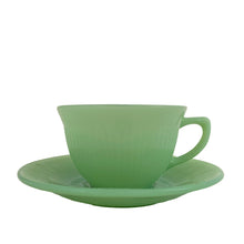 Load image into Gallery viewer, Vintage Fire-King &quot;Jane Ray&quot; pattern pressed glass jadeite cup and saucer featuring a ribbed pattern. Crafted by the Anchor Hocking, USA, 1945 - 1963. Highly collectible and suits a number of decor styles including farmhouse, shabby chic, mid-century modern, and kitsch kitchen. In excellent condition, free from chips/cracks/repairs. Maker&#39;s mark present on the bottom of each piece, see photos. Cup measures 3 3/4 x 2 1/4 inches | saucer measures 4 1/8 inches
