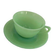 Load image into Gallery viewer, Vintage Fire-King &quot;Jane Ray&quot; pattern pressed glass jadeite cup and saucer featuring a ribbed pattern. Crafted by the Anchor Hocking, USA, 1945 - 1963. Highly collectible and suits a number of decor styles including farmhouse, shabby chic, mid-century modern, and kitsch kitchen. In excellent condition, free from chips/cracks/repairs. Maker&#39;s mark present on the bottom of each piece, see photos. Cup measures 3 3/4 x 2 1/4 inches | saucer measures 4 1/8 inches
