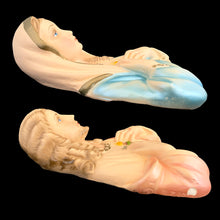 Load image into Gallery viewer, Side profile of both 1950s chalkware religious wall plaques lying flat, showing hollow relief back, soft pastel paint in pink and blue, and Michigan Artistic Creations embossed text along base edge
