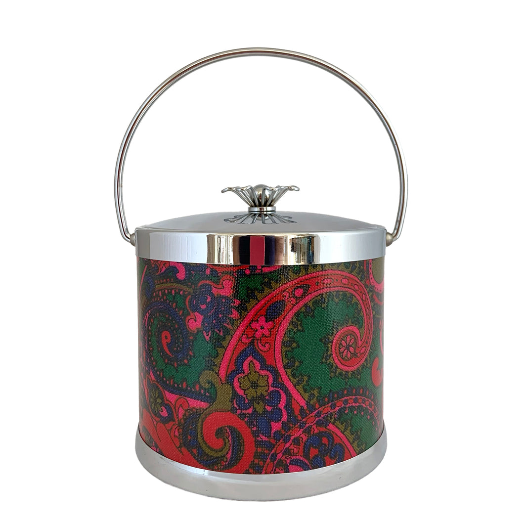 Vintage ice bucket featuring a chrome base, jewel-toned paisley bucket, topped with a chrome handle and lid with sculptural metal flower white plastic interior. Crafted by Serv-Master, USA, circa 1960s. A fabulous example of mid-century design and style!

In excellent used condition. Marked on the bottom Serv-Master Creations.

Measures 7 3/4 x 8 inches (not incl. handle)