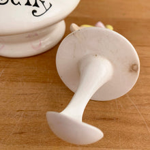 Load image into Gallery viewer, Rare vintage mid-century era Jolly Girls ceramic Jam&#39;n Jelly jar with spoon. Holt Howard, Japan, imported by LIpper and Mann, 1950s. Add this adorable kitschy piece to your collection!

In very good vintage condition, no chips/cracks/repairs, minor discolouration on the underside of the lid where the ceramic stilt pin was placed during firing. Marked Japan.

Measures 3 3/4 x 3 3/4 x 5 1/4 inches
