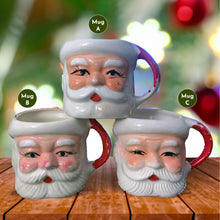 Load image into Gallery viewer, Vintage jolly red and white Santa Claus figural face ceramic mug...nostalgia from holidays gone by! Likely made for Binns Department Store in Pittsburgh, Pennsylvania and crafted in Japan, circa 1960s. Add some holiday magic to your Christmas decor by filling this charming mug with candy canes or top with an ornament!

In as found vintage condition, no chips, cracks or repairs. There is wear to the cold paint on all three mugs. Mugs A and C are marked Japan.

Measures 3 x 3 inches, not incl. handle
