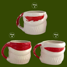 Load image into Gallery viewer, Vintage jolly red and white Santa Claus figural face ceramic mug...nostalgia from holidays gone by! Likely made for Binns Department Store in Pittsburgh, Pennsylvania and crafted in Japan, circa 1960s. Add some holiday magic to your Christmas decor by filling this charming mug with candy canes or top with an ornament!

In as found vintage condition, no chips, cracks or repairs. There is wear to the cold paint on all three mugs. Mugs A and C are marked Japan.

Measures 3 x 3 inches, not incl. handle
