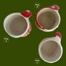Load image into Gallery viewer, Vintage jolly red and white Santa Claus figural face ceramic mug...nostalgia from holidays gone by! Likely made for Binns Department Store in Pittsburgh, Pennsylvania and crafted in Japan, circa 1960s. Add some holiday magic to your Christmas decor by filling this charming mug with candy canes or top with an ornament!

In as found vintage condition, no chips, cracks or repairs. There is wear to the cold paint on all three mugs. Mugs A and C are marked Japan.

Measures 3 x 3 inches, not incl. handle
