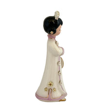 Load image into Gallery viewer, Josef Originals Good Luck figurine, left side profile view, showing the applied white flower embellishments along the kimono front opening, pink trim with gold gilt, black hair bun with white headdress
