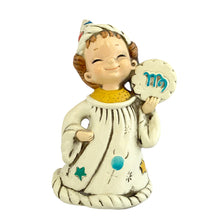 Load image into Gallery viewer, Josef Originals Virgo Zodiac wizard figurine, front view, cream ceramic robe decorated with hand-painted teal and yellow stars and teal dots, yellow textured collar, right hand holding a cloud-shaped medallion with teal Virgo glyph, white wizard hat with multicolour celestial motifs, smiling hand-painted face
