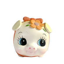 Load image into Gallery viewer, This adorable kitschy vintage Kawaii white piggy bank features a big eyed smiling face with pink bow, glittery flowers and curly tail. Crafted by Sanrio, Japan, 1980s. A wonderful collectible decor piece!

In great vintage condition, no chips or cracks. Black rubber stopper is intact.

Measures 3 1/2 x 2 3/4 x 3 inches
