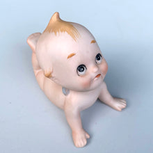 Load image into Gallery viewer, Sweet vintage bisque porcelain Kewpie doll figurine with blue wings, model KW7546. Crafted by Lefton, Japan, circa 1960s. This darling Kewpie figurine is laying down on his tummy, pushed up on its hands looking skyward with one leg curled up. So cute!  In excellent condition, no chips/cracks/repairs.  Measures 3 1/4 x 2 3/4 x 2 1/2 inches
