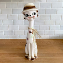 Load image into Gallery viewer, Vintage kitsch long neck, big eyed hand painted ceramic cat figurine. Crafted in Japan, 1960s. An adorable piece to add to your kitsch or cat collection!

In excellent vintage condition, no chips/cracks/repairs. There is minor glaze miss on the hat brim.

Measures 3 x 3 3/4 x 12 1/2 inches
