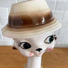 Load image into Gallery viewer, Vintage kitsch long neck, big eyed hand painted ceramic cat figurine. Crafted in Japan, 1960s. An adorable piece to add to your kitsch or cat collection!

In excellent vintage condition, no chips/cracks/repairs. There is minor glaze miss on the hat brim.

Measures 3 x 3 3/4 x 12 1/2 inches
