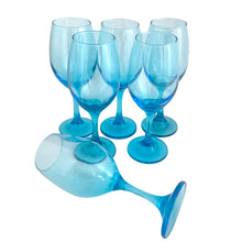 Load image into Gallery viewer, Five Libbey Laser Blue LRS60 wine glasses standing upright with one laid on its side in the foreground, showing the full stem and base profile
