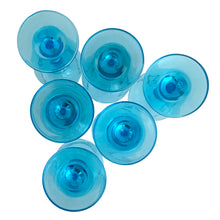 Load image into Gallery viewer, Bottom view of six Libbey Laser Blue wine glasses, showing circular bases and stem nubs in vivid aqua blue
