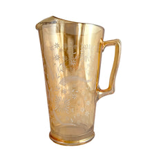 Load image into Gallery viewer, Gorgeous vintage mid century era iridescent marigold carnival glass pitcher featuring the &quot;Late Sunflowers&quot; pattern of wildflowers and ferns in white. Crafted by Jeannette Glass, USA, 1950s. The perfect way to serve your favourite beverage with vintage flare!&nbsp;  In excellent condition, minor wear. Flea bites along the mold release at the interior rim, see photos.  Measures 5 5/8 x 9 5/8 inches  Capacity 56 ounces
