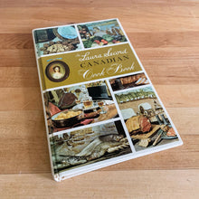 Load image into Gallery viewer, Laura Secord is known for its fabulous confections and in a joint effort with the Canadia Hoe Economics Assocation they created this quintessential Canadian cook book featuring authentic Canadian recipes from across the country. Its 192 pages are filled with wonderful recipes along with many colour illustrations (Frank Neufeld. Published by McClelland and Stewart Ltd. Canada, 1966. This is the fifth edition 1971.   In great vintage condition with normal age-related yellowing.   
