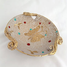 Load image into Gallery viewer, A fabulous piece of Bitossi mid-century lava pebble glazed pottery dish featuring a gold butterfly and three decorative scrolled and curled handles. Artisan crafted in Italy, and imported to North America by Irving Richards of Raymor, USA, circa 1960s. Makes a lovely trinket or candy dish. A phenomenal gift for the MCM lover. Excellent condition, free from chips/cracks/repairs. Marked Italy. Measures 6 1/2 x 2 3/8 inches
