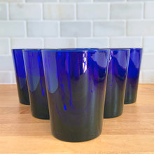 Load image into Gallery viewer, Set of six vintage Libbey Flare cobalt blue old fashioned tumblers arranged in a triangle formation, front view showing smooth tapered sides
