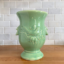 Load image into Gallery viewer, Light green McCoy Pottery handled vase with embossed bird design, front view
