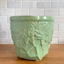Load image into Gallery viewer, Highly collectible vintage light green roses ceramic jardiniere planter. Crafted by McCoy Pottery, USA, 1950. The perfect home for your favourite greenery or flowers! This rare piece is a must-have for any art pottery collector!

In excellent vintage condition, no chips/cracks/repairs, normal age-related crazing and manufacturer&#39;s glaze pops. Maker&#39;s mark.

Measures 7 1/2 x 6 5/8 inches
