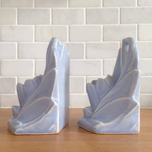 Load image into Gallery viewer, Striking vintage matte lilac water lily bookends. Crafted by Nelson McCoy Pottery, 1940s. These rare bookends are a must for any McCoy art pottery collector!

In as found vintage condition, with a couple of chips, see photos. Maker&#39;s marks on both pieces.

Measures 6 1/4 x 5 1/2 inches
