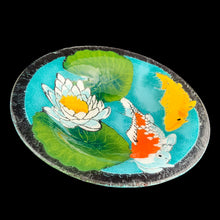 Load image into Gallery viewer, Exquisite vintage fused art glass bowl, featuring a colourful pond scene with vibrant Koi fish and elegant water lilies. Designed by talented artisan Peggy Karr who operated one of the USA&#39;s premier fused glass studios from 1987 - 2016. Whether for serving or as home decor, this vivid colour palette adds a burst of energy to any space, making it a must-have for every art lover! In excellent condition, free from chips. Signed by the artist. Measures 13 x 2 1/2 inches
