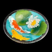 Load image into Gallery viewer, Exquisite vintage fused art glass bowl, featuring a colourful pond scene with vibrant Koi fish and elegant water lilies. Designed by talented artisan Peggy Karr who operated one of the USA&#39;s premier fused glass studios from 1987 - 2016. Whether for serving or as home decor, this vivid colour palette adds a burst of energy to any space, making it a must-have for every art lover! In excellent condition, free from chips. Signed by the artist. Measures 13 x 2 1/2 inches
