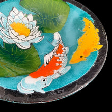 Load image into Gallery viewer, Exquisite vintage fused art glass bowl, featuring a colourful pond scene with vibrant Koi fish and elegant water lilies. Designed by talented artisan Peggy Karr who operated one of the USA&#39;s premier fused glass studios from 1987 - 2016. Whether for serving or as home decor, this vivid colour palette adds a burst of energy to any space, making it a must-have for every art lover! In excellent condition, free from chips. Signed by the artist. Measures 13 x 2 1/2 inches
