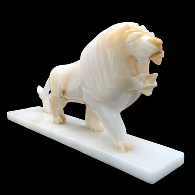 Beautifully hand carved vintage mid-century onyx marble roaring standing lion statue on a rectangular base. This heavy statue would look amazing sitting atop atop of a stack of books or as a book end, or as a standalone piece of decor.  In vintage condition with wear at the corners and there is a small chips at the corner of its mouth, see photos  Measures 12 5/8 x 2 1/2 x 6 5/8 inches