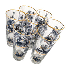 Load image into Gallery viewer, Set of seven vintage pint glasses featuring black, white and gold locomotive trains. Crafted by Libbey Glass, circa 1950s. A great addition to your barware collection or perfect for the train enthusiast!  In excellent condition, no chips. Marked on the bottom with the Libbey &quot;L&quot;.  Measures 3 1/8 x 6 1/2 inches  Capacity 16 ounces
