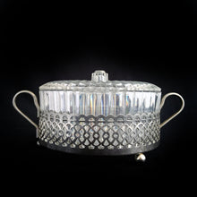 Load image into Gallery viewer, Clear faceted lucite plastic lidded vanity box nestled in a silver ormolu handled caddy. The silver-toned metal ormolu caddy has two handles and three ball feet. An excellent addition to your boudoir or bathroom vanity for powder or trinkets. In excellent vintage condition, free from chips. Measures 5 1/8 x 3 1/2 (not incl. handles)
